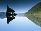 The Partially Submerged Wreckage of a Ship Reflected in a Scenic Bay