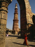 The 239-Foot Tall Qutab Minar Seen Through the Arch of a Mosque Ruin