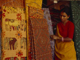 Woman Looks at Traditional Indian Fabrics with Patches and Stitching