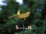 A Weather Vane with a Rowboat and Skipper Figurine Atop It