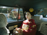 Kimono-Clad Geisha Sits in the Back of a Cab