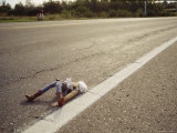 A Discarded Puppet in the Middle of a Road