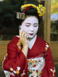 A Kimono-Clad Geisha Talks on a Cell Phone