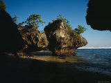 Small Sunlit Trees Sit on Top of the Giant Rocks of Bingin Beach