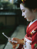 A Kimono-Clad Geisha Dials Her Cell Phone