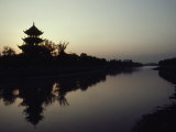 Chinese Pavilion Silhouetted against an Orange Twilight Sky  Sichuan Province  China