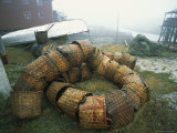 A Fishermans Baskets Piled on the Shore Near a Boat