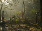 A Man and His Sisters Warm Themselves in Rays of the Winter Sun