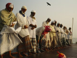 Muslim Men Wearing Skull Caps  Scarves and Lunghis Prepare to Pray