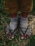 A Sulfur Miner Wears Slippers and Worn Fabric with Holes for Socks