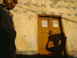 A Man Stands Outside the Yellow Home of a Wealthy Businessman