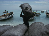 Man Loads Bags of Cargo Into Small Wooden Boats  Haiti  West Indies