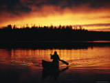 Silhouetted Canoeist on the Water at Sunset
