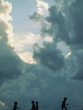 Children Playing with Toy Gliders Under a Cloud-Filled Sky  Wichita  Kansas