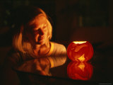 A Woman Illuminated by a Halloween Jack-O-Lantern