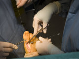 A Surgeon Sews a Foot Back Together after an Operation
