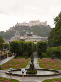 Tourists Enjoy a Rainew York Day in the Gardens of the Palace  Salzburg  Austria
