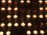 A Close View of Votive Lamps in a Church