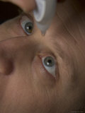 A Man Puts in Eyedrops