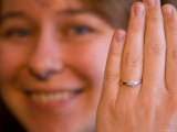 A Happy Female Holds up Her Diamond Engagement Ring