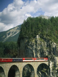 A Train Passes into a Tunnel in the Mountains of Switzerland