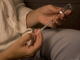 A Woman Draws Medicine into a Syringe