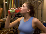 A Woman Drinks During a Workout