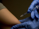 A Woman Receives a Shot in the Arm