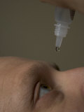 A Man Puts in Eyedrops
