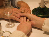 A Family Holds Hands at a Restaurant