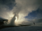 Skiier Peers Into a Pool Heated by Magma below the Earth's Surface  Mammoth Lakes  California