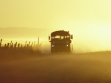 Rural School Bus Driving Along Dusty Country Road  Oregon  USA