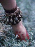 Person's Hand Reaching Into the Ground Wearing Bronze Bracelet
