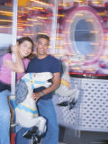 Young Couple Riding Carousel