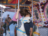 Young Couple Kissing on Carousel