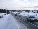 Cars Speeding Along Snowy Highway