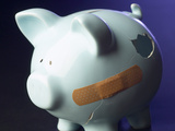 Bandaid on Broken and Cracked Piggy Bank