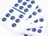 Pile of Black and White Dominoes Against White Background
