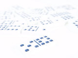 Line of Black and White Dominoes Against White Background