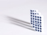 Line of Three Black and White Dominoes Against White Background