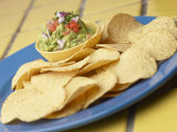 Tasty Nacho Chips Beside Bowl of Fresh Guacamole