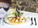 Elegant Glass of Red Wine Beside Tasty Gourmet Salad