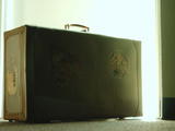 Vintage Suitcase Covered in Travel Tags