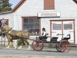Horse-Drawn Wagon Driving Past Blacksmith Shop