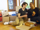 Couple Having Pizza and Red Wine in Empty Apartment