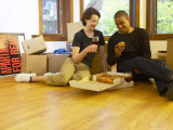 Couple Eating Pizza and Drinking Red Wine on Moving Day