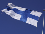 The Flag of Finland on White Fabric with a Blue Cross Against Blue Sky