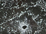 Close-up of a Hole in Cracked and Shattered Glass