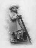 Girl in Smart Hat and Coat with Her Scooter