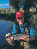 Woman Fly Fishing in Co  Holding Fish